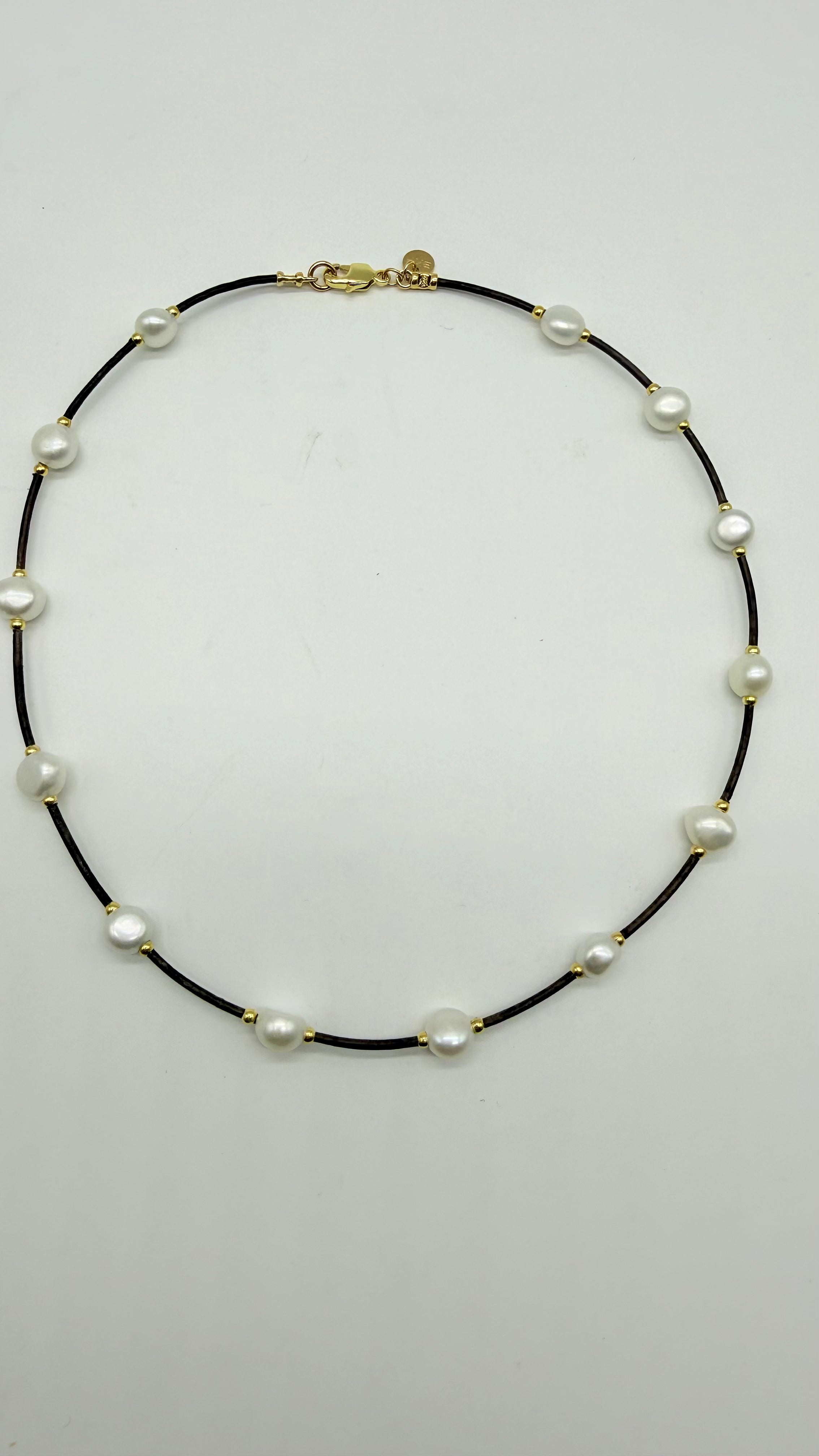 Leather , pearls, gold beads on leather